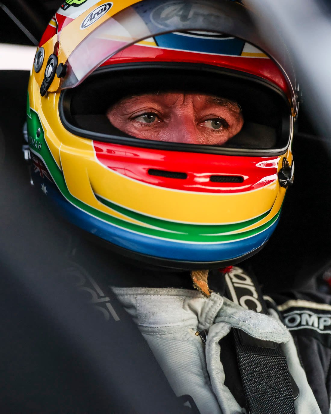 Ian McMah in the cockpit of car 50, wearing his rainbow helmet.